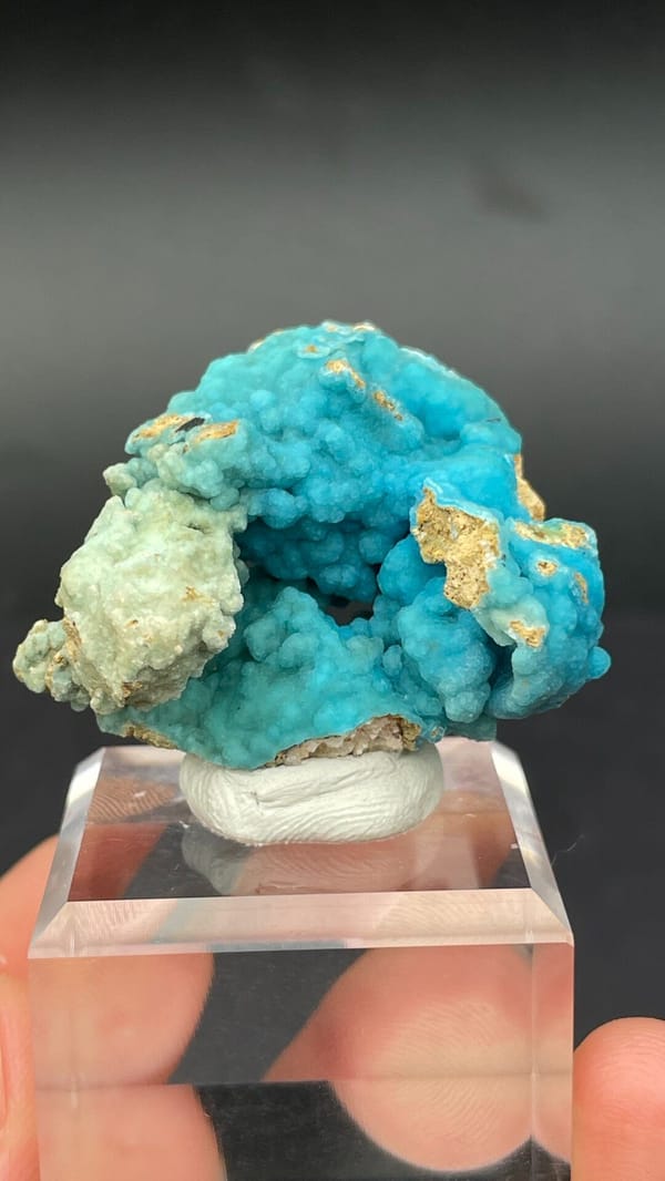 Turquoise botryoidal hemimorphite crust from Yunnan, China, on an acrylic stand, top view