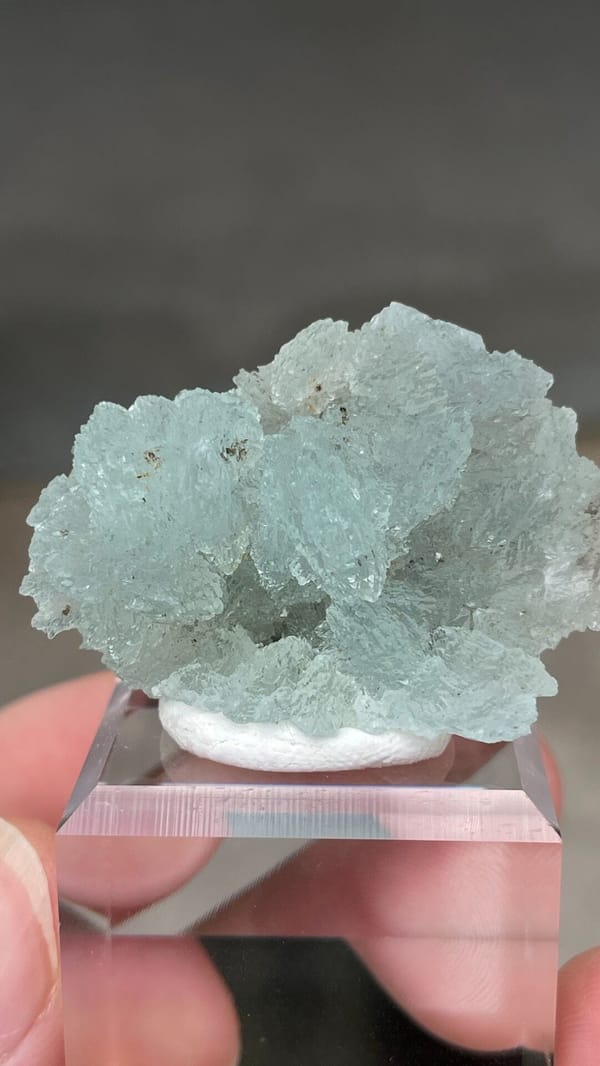Pale blue bladed hemimorphite crust from Yunnan, China, on an acrylic stand