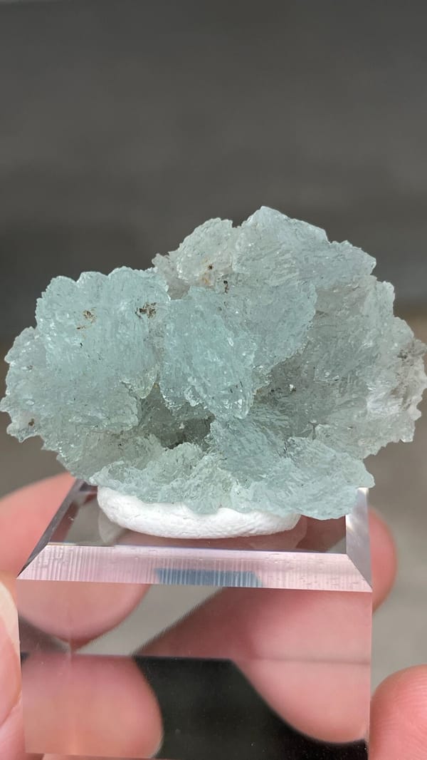 Pale blue bladed hemimorphite crust from Yunnan, China, on an acrylic stand, second angle