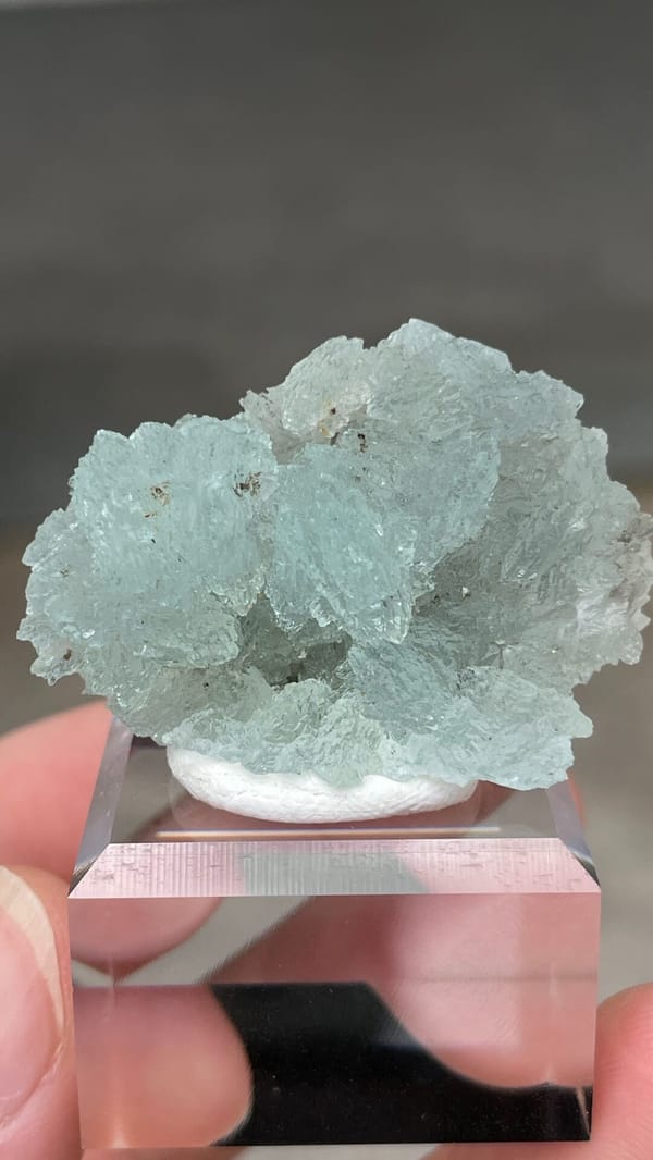 Pale blue bladed hemimorphite crust from Yunnan, China, on an acrylic stand, top view
