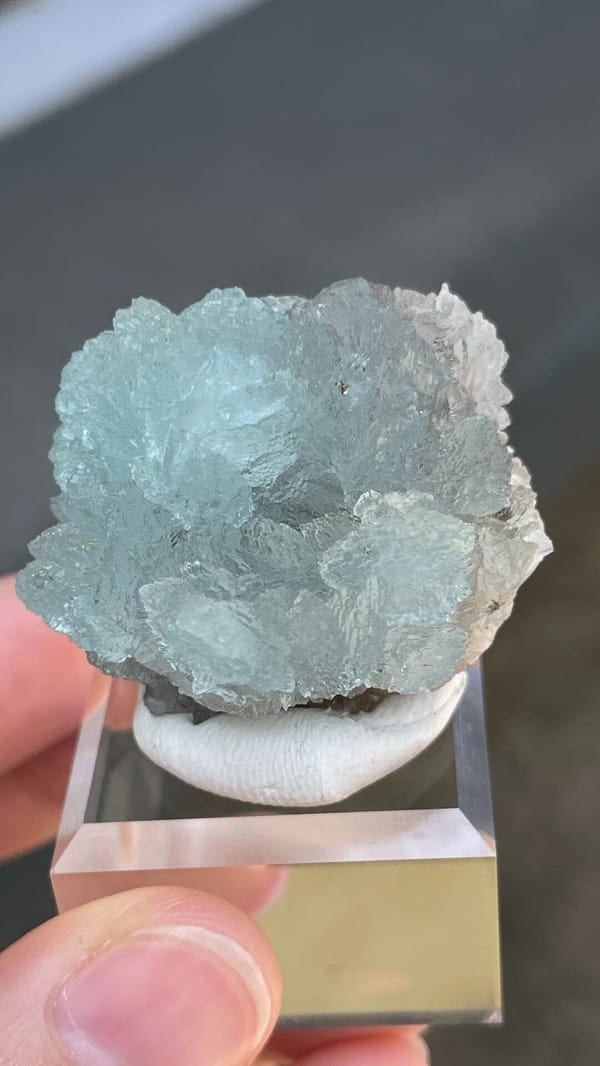 Pale blue hemimorphite fan from Yunnan, China, on an acrylic stand