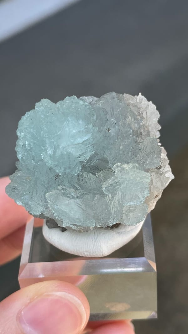 Pale blue hemimorphite fan from Yunnan, China, on an acrylic stand, second angle