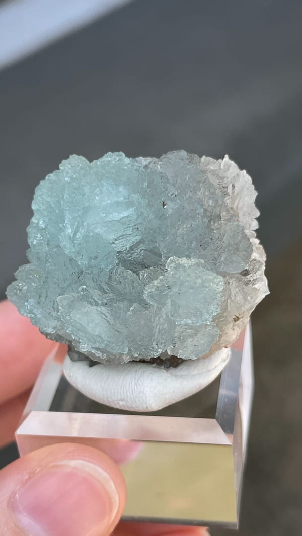 Pale blue hemimorphite fan from Yunnan, China, on an acrylic stand, reverse side