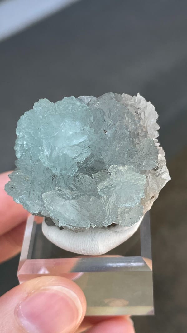 Pale blue hemimorphite fan from Yunnan, China, on an acrylic stand, top view