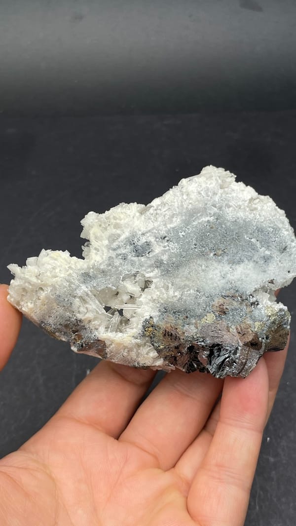 White quartz crust over dark marmatite sphalerite from Peru, top view
