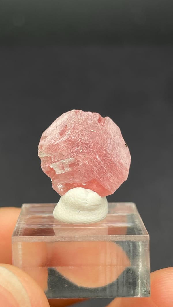 Pink rhodochrosite rosette on quartz from Wuzhou, Guangxi, China, on a stand