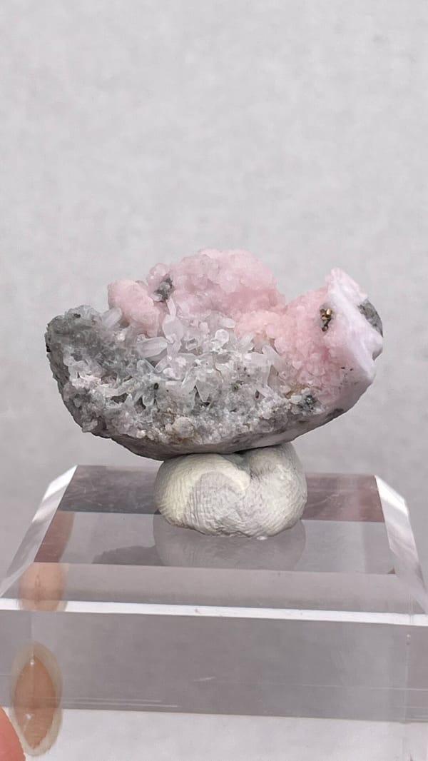 Pink botryoidal rhodochrosite cap on grey quartz from Romania, detail of the matrix contact