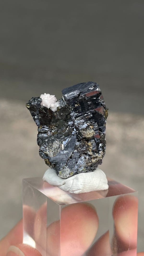 Metallic galena with chalcopyrite and pink rhodochrosite from Peru, close-up of the crystal faces