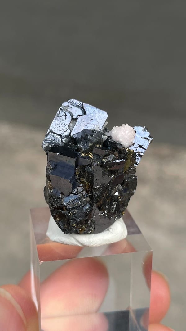 Metallic galena with chalcopyrite and pink rhodochrosite from Peru, detail of the matrix contact