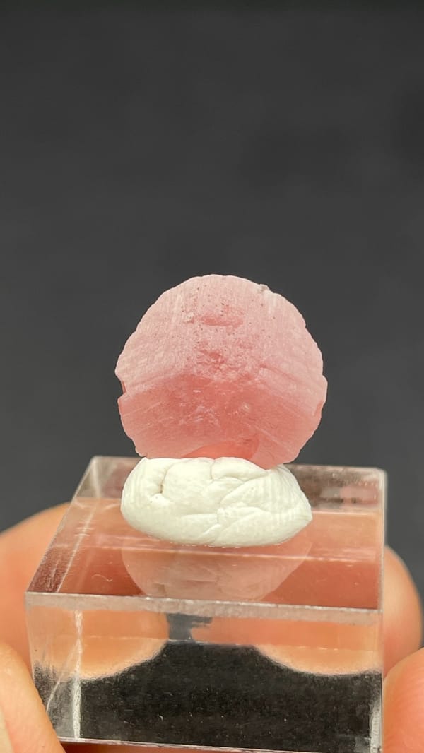 Rose-pink rhodochrosite shell on quartz from Wuzhou, Guangxi, China, close-up of the crystal faces