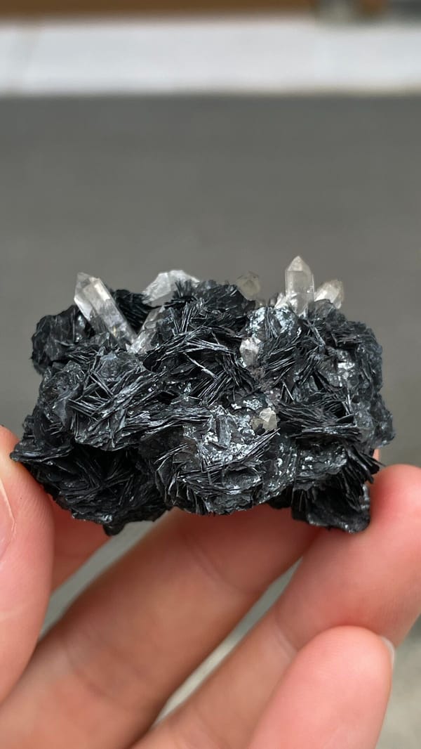 Black metallic specular hematite rosettes with quartz from Guangdong, China, reverse side