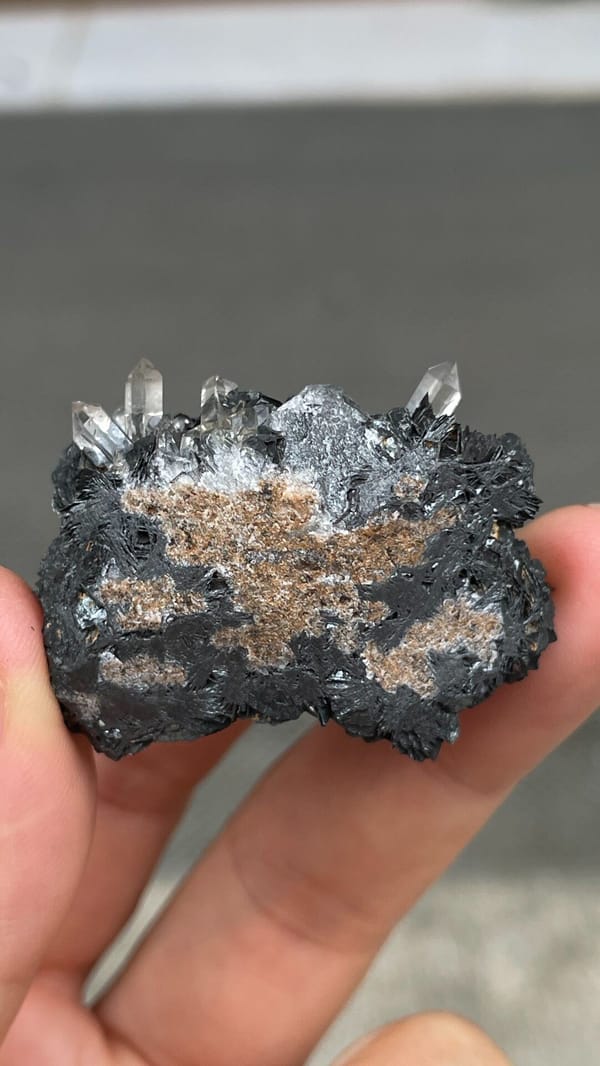 Black metallic specular hematite rosettes with quartz from Guangdong, China, top view