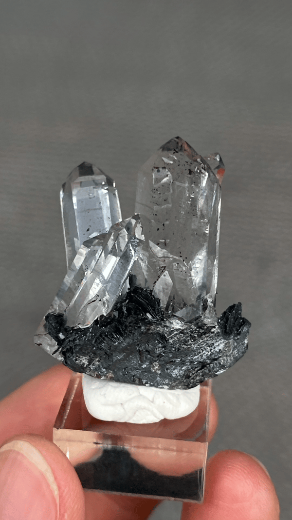 Clear quartz points on black specular hematite from Guangdong, China, second angle