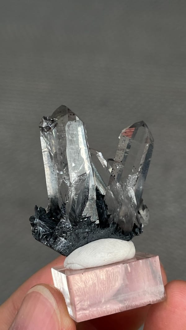 Clear quartz points on black specular hematite from Guangdong, China, reverse side