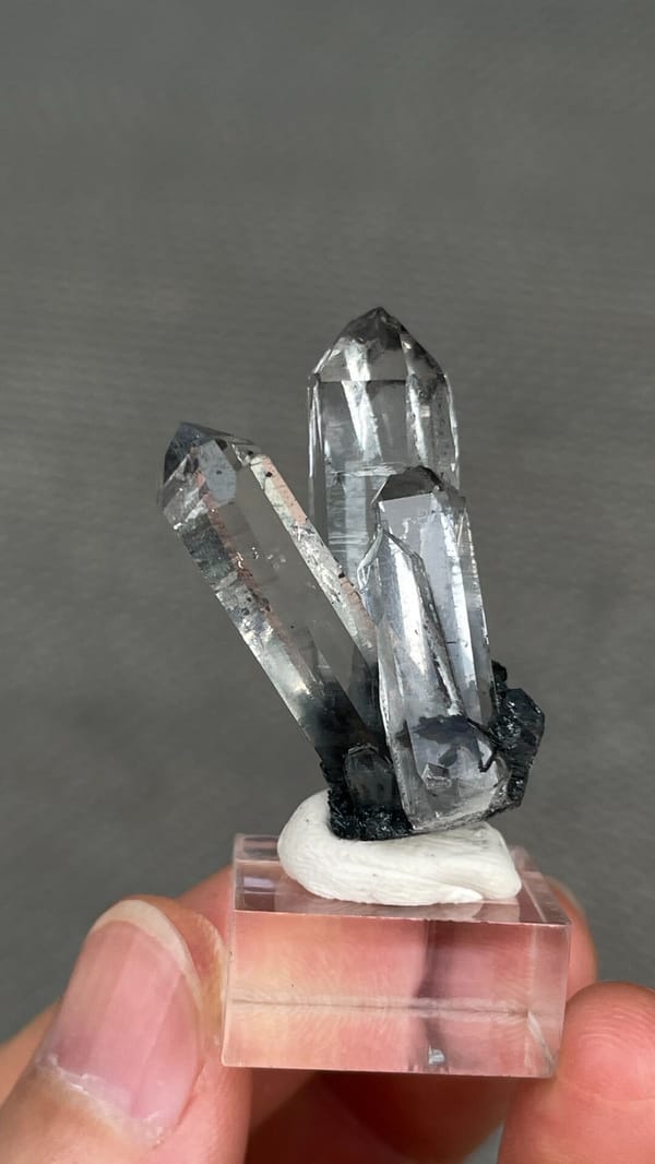 Clear quartz points on black specular hematite from Guangdong, China, top view