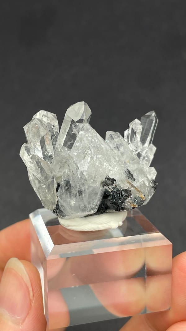 Long clear quartz points on specular hematite from Guangdong, China, close-up of the crystal faces