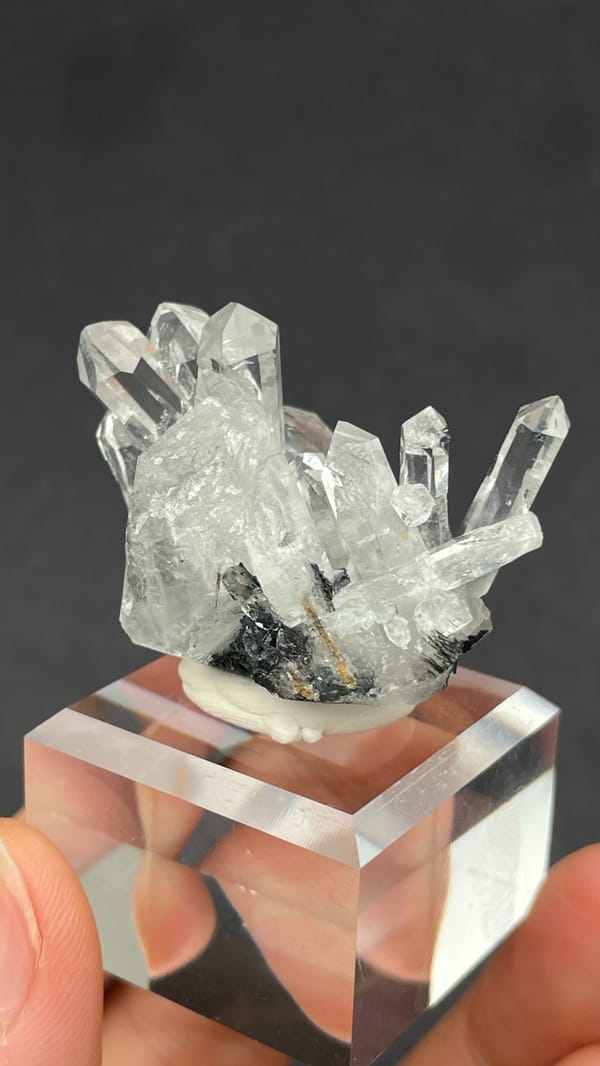 Long clear quartz points on specular hematite from Guangdong, China, reverse side