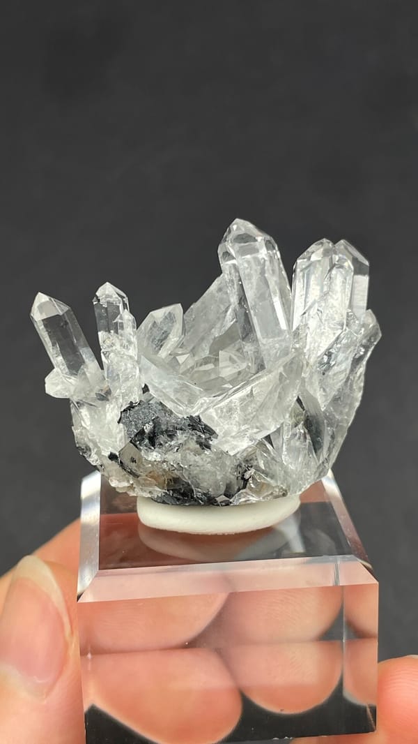 Long clear quartz points on specular hematite from Guangdong, China, detail of the matrix contact