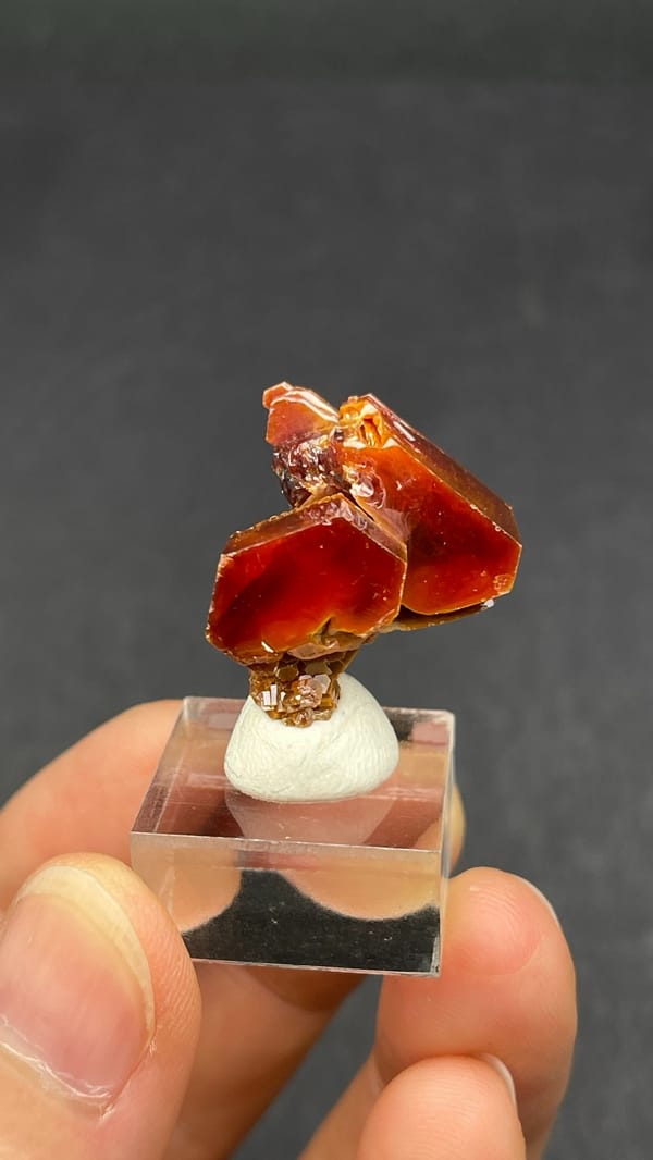 Dark red vanadinite crystal group from Morocco, on an acrylic stand, top view