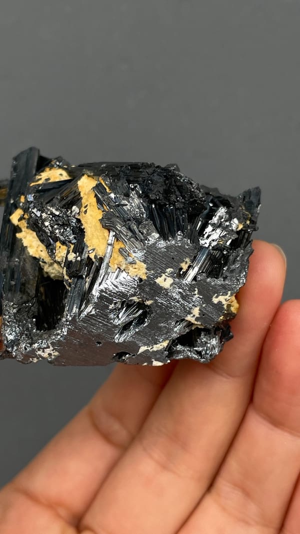 Radiating steel-grey stibnite blades from Yunnan, China, detail of the matrix contact
