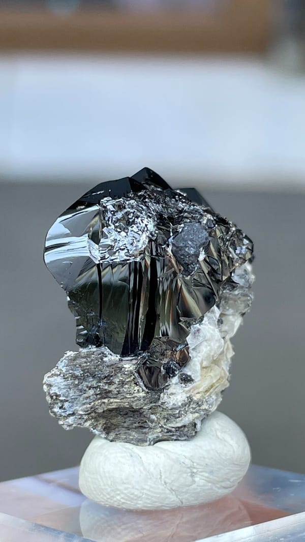 Black lustrous cassiterite crystal group on white matrix from Xuebaoding, Sichuan, reverse side
