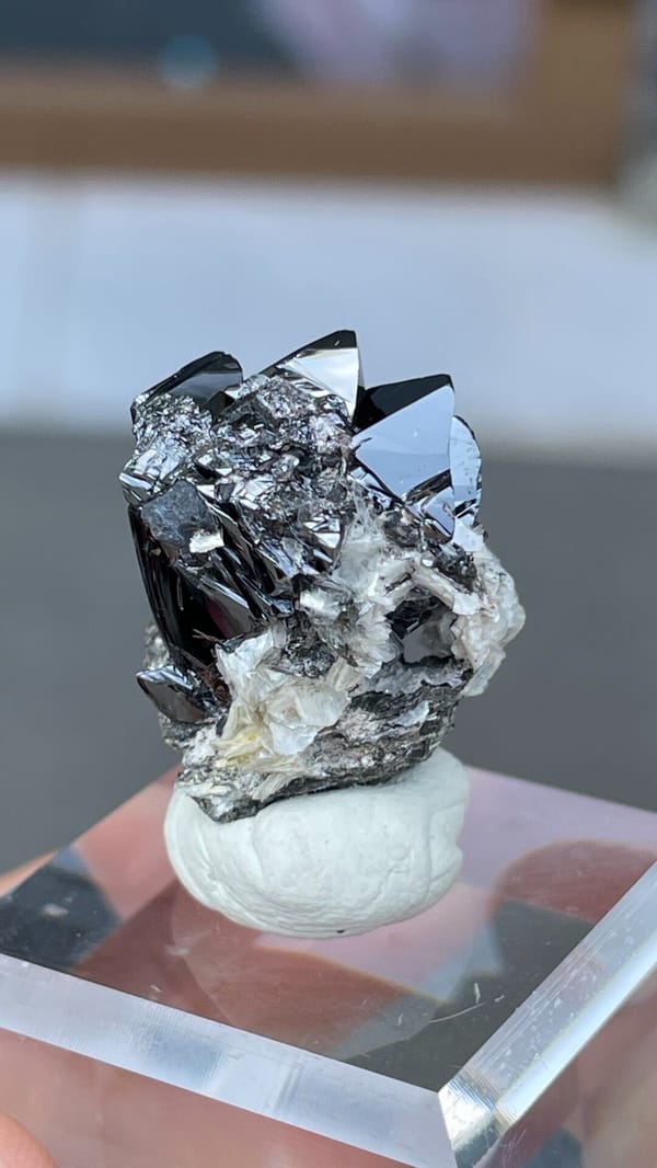 Black lustrous cassiterite crystal group on white matrix from Xuebaoding, Sichuan, top view