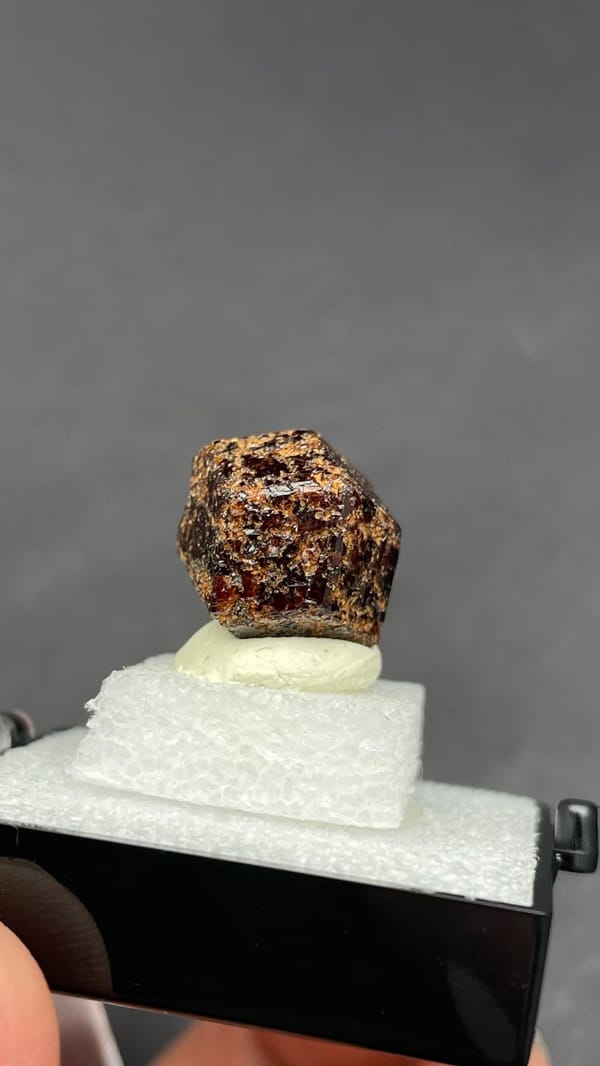 Dark brown dodecahedral andradite garnet crystal from Handan, Hebei, China, close-up of the crystal faces