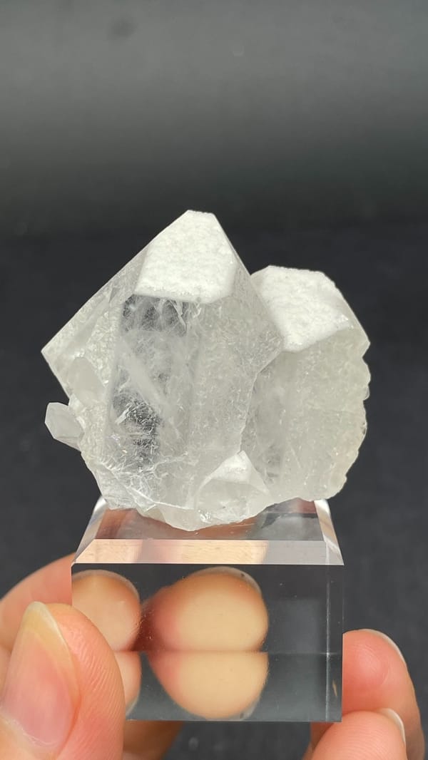 Blocky white baryte crystal with quartz from Jinkouhe, Sichuan, China, on a stand
