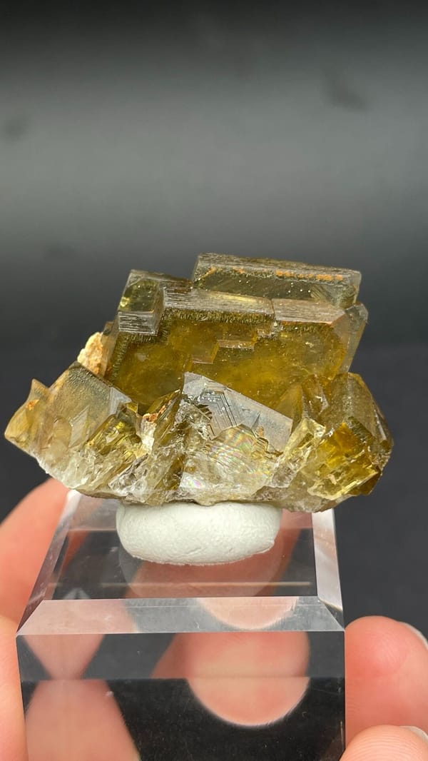 Amber-yellow tabular baryte crystals from Peru, on an acrylic stand
