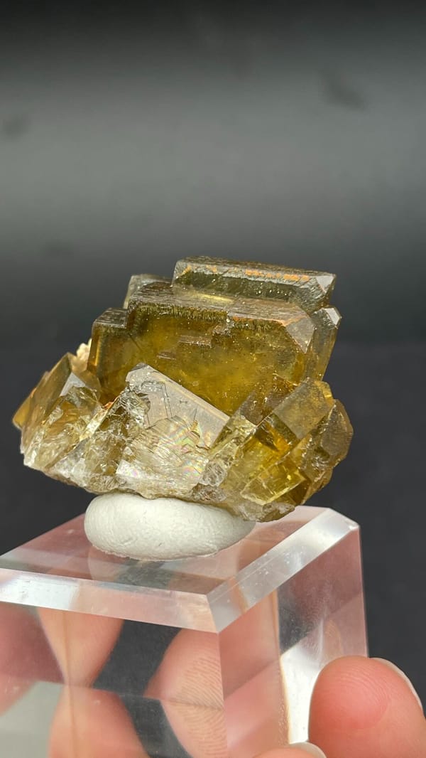 Amber-yellow tabular baryte crystals from Peru, on an acrylic stand, second angle