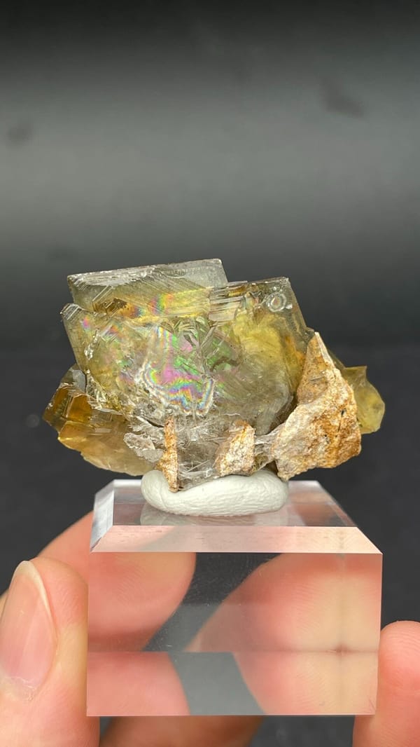 Amber-yellow tabular baryte crystals from Peru, on an acrylic stand, top view