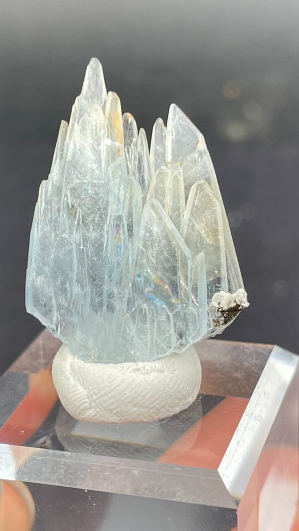 Pale blue transparent baryte blades from Morocco, on an acrylic stand, second angle