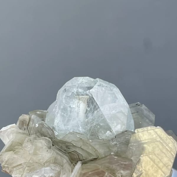 Pale blue Xuebaoding aquamarine crystal in a silvery mica rosette — alternate view