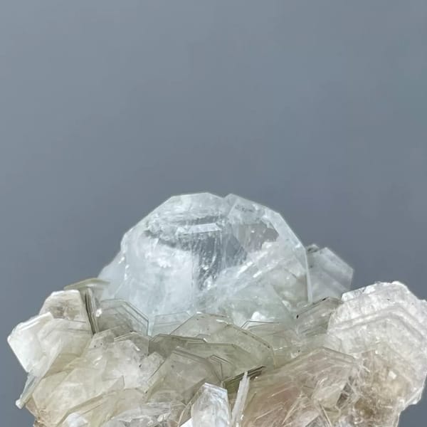 Pale blue Xuebaoding aquamarine crystal in a silvery mica rosette — alternate view