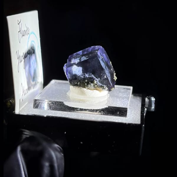 Deep blue-purple Yaogangxian fluorite cube in display box — detail view