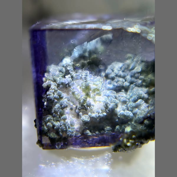 Deep blue-purple Yaogangxian fluorite cube in display box — detail view