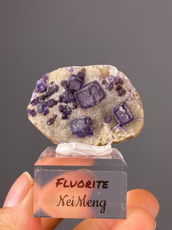 Purple Fluorite specimen from Inner Mongolia, China featuring purple cubes on pale matrix