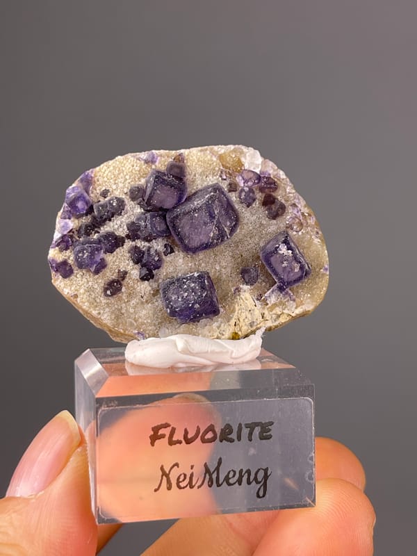 Purple Fluorite specimen from Inner Mongolia, China showing purple cubes on pale matrix