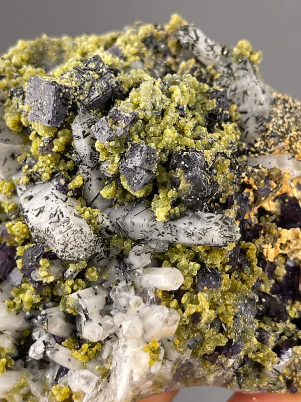 Included clear quartz and purple cubes visible on purple fluorite specimen from Yaogangxian Mine, Hunan, China