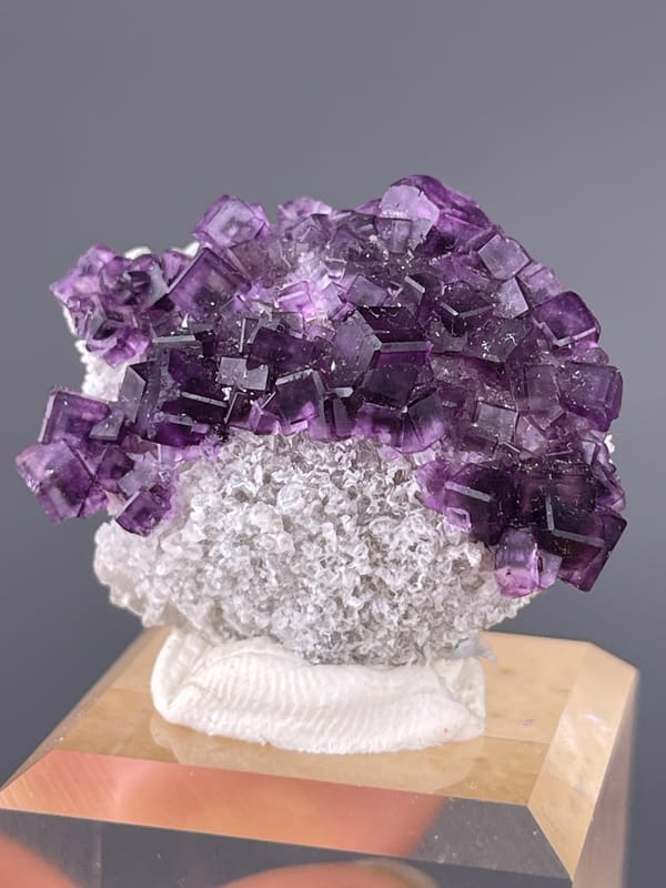 Purple Zoned Fluorite specimen from Zhejiang, China, defined by stepped purple cubic crystals