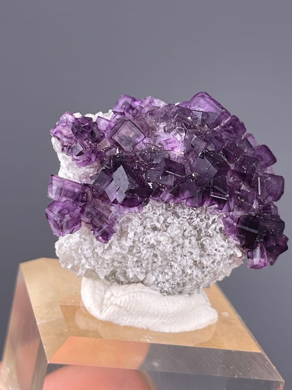Purple Zoned Fluorite specimen from Zhejiang, China presenting stepped purple cubic crystals