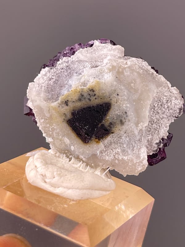 Stepped purple cubic crystals visible on purple zoned fluorite specimen from Zhejiang, China