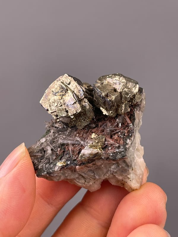 Pyrite specimen from Longyan, Fujian, China highlighting striated silver-brassy blocky crystals