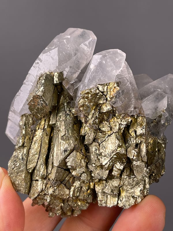 Brassy crystals beside clear quartz clearly visible on this pyrite specimen