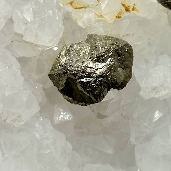Two pyritohedral pyrite crystals on white quartz druse from Guangxi, China, view 4 of 12