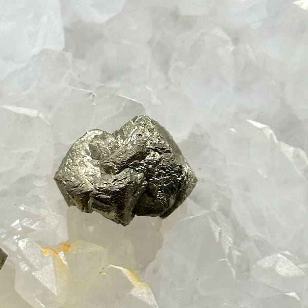 Two pyritohedral pyrite crystals on white quartz druse from Guangxi, China, view 5 of 12