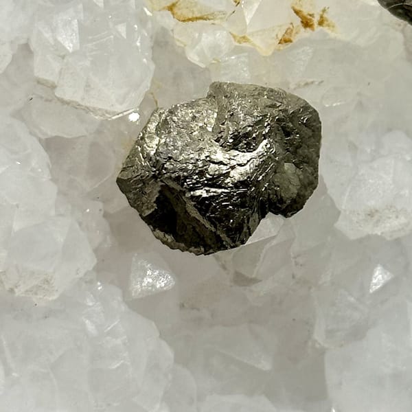 Two pyritohedral pyrite crystals on white quartz druse from Guangxi, China, view 10 of 12