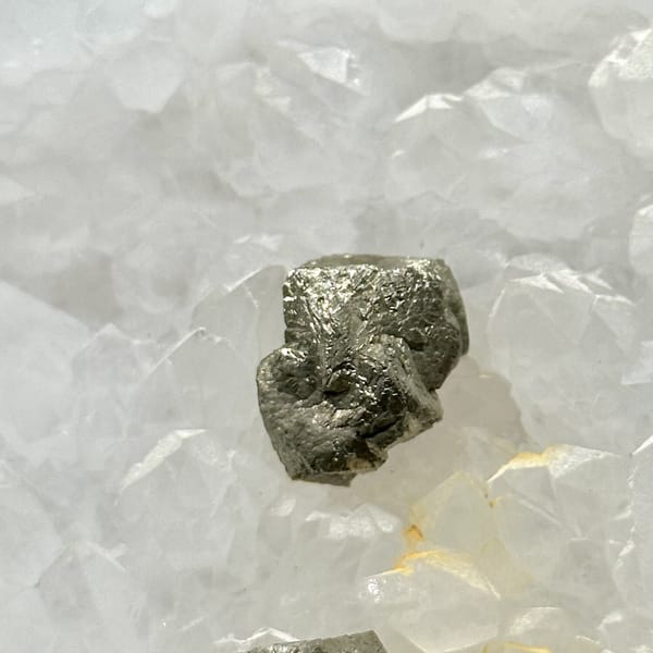 Two pyritohedral pyrite crystals on white quartz druse from Guangxi, China, view 11 of 12