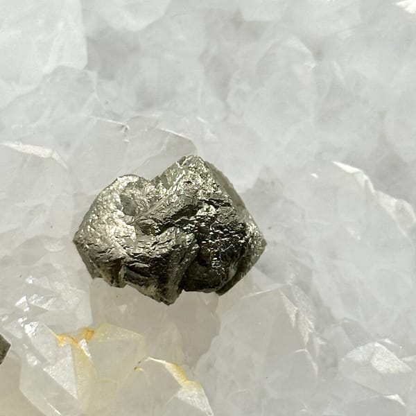 Two pyritohedral pyrite crystals on white quartz druse from Guangxi, China, view 12 of 12