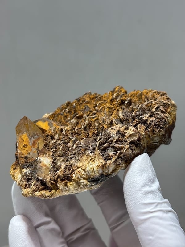 Brown mica plate with small quartz crystals from Xuebaoding, Sichuan, China, close-up of the crystal faces